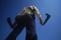 Paratrooper drying his socks on the Mekong going towards Kroch Chmar.  Viewed from below against sky.