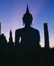 Silhouette of buddha on temple - pink mauve sky