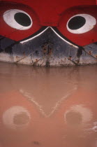 Vietnam, My Tho, Detail of boat with traditional painted decoration depicting a pair of guarding eyes