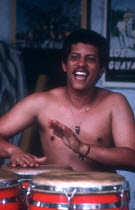 Salsa musician playing red drums with his hands
