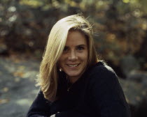 Portrait of blonde haired  smiling girl. Dark blue jumper and necklace. mf.1295.1058