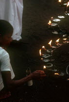 People lighting lamps during Wessac