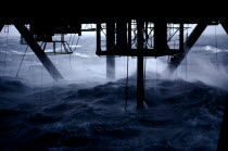 Drill entering the sea below a north sea oil rig