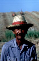 Portrait of a sugar worker in field wearing a straw hat