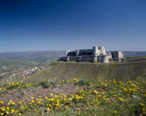 Crusader Castle in distance on plateau with village partly seen below