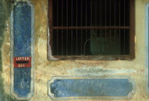 Detail of colourful but weathered post office window
