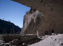 Visitors exploring the caves from the ancestrial Pueblo Indian dwellings.European Mexican North America United States of America American Blue Destination Destinations Hispanic History Historic Holid...