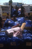 UN troops unloading new arrivals baggage at a repatriation camp.