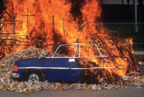 Burning offerings  including an image of a car on the first anniversary of a death.