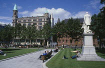 City Hall lawns in Summer with people ralaxing in the sunshine.Bal Feirste Eire Irish Northern Europe Republic Beal Feirste Blue Destination Destinations European Holidaymakers Ireland Poblacht na h...