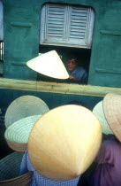 Hat sellers beside train.