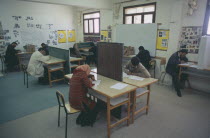 Students sitting an English exam. All male and one female.Banghazi