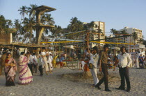 Chowpatty Beach.  Children on merry go round and evening crowds.Mumbai Bombay