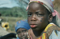 Portrait of young girl with facial tattoos.