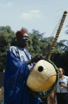 Manoinka musician playing the Kora which is a strung gouro instrument