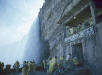 The Horseshoe Falls waterfall Journey behind the Falls people in yellow macs underneath the falls