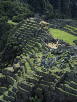 View over the central plaza with main temple ruins and the walled terraces below Cuzco Cusco