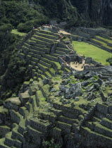 View over the central plaza with main temple ruins and the walled terraces below Cuzco Cusco