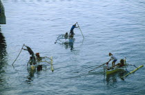 fishermen in small outriggers.
