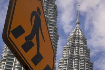 Pedestrian crossing sign with the Petronas Towers behind
