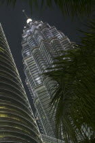 Angled view of the Petronas Towers illuminated at night