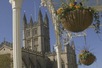 View of the east face of Bath Abbey seen from under veranda with hanging baskets