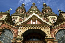 Angled view of church entrance and golden onion domes on the rooftops