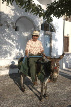 Man on a donkey in the streetThira Fira Santorini