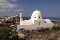 Whitewashed Church with domed roof overlooking the townThira Fira Santorini