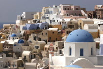 View over the towns architecture with blue domed buildingsThira Fira Santorini