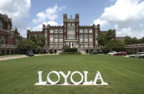 Loyola University with word LOYOLA in white letters on the lawn in the foreground