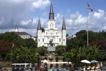 French Quarter. Jackson Square with equestrian statue of Andrew Jackson in front of St Louis Cathedral and horse drawn carriages in the foreground