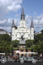French Quarter. St Louis Cathedral on Jackson Square with horse drawn carriages in the foreground