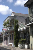 French Quarter. Typical architecture with ironwork balconies and American flag