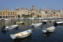 View over moored boats toward waterfront architecture of the town