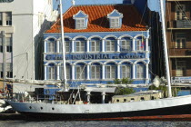 Willemstad harbour front bank with boat moored in front
