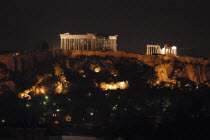 View toward the hilltop Acropolis with the Parthenon and other ruins illuminated at night