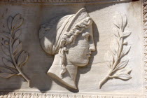 Carved stone relief depicting womans head and profile
