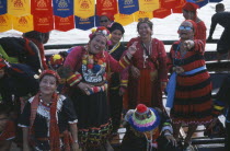 Group of women spectators at boat races on the Mekong River.