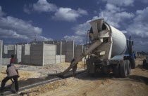 Laying concrete pavement on building site.