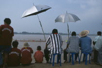 Spectators watching boat races on the Mekong River.