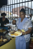 Female cook serving meal.
