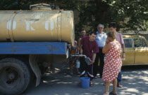 Milk tanker delivering milk to people living in the city suburbs.