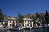 Crimean Coast.  Waterside buildings with boats moored beside quay.