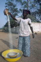Woman winnowing rice.West Africa