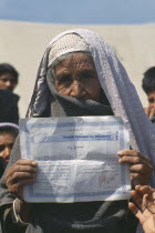 UNHCR camp for refugees from Afghanistan.  Elderly woman holding up certificate indicating that she has received medical training.United Nations High Commissioner for Refugees