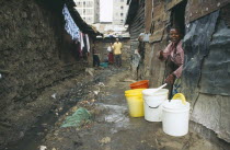 Village One residents in the narrow alleys of the notorious no go slum without sanitation being cleaned up by residents after cholera outbreaks