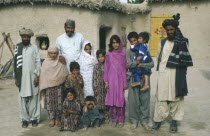 Family portrait of Baluchi men and children.  Modesty prevents the wives from being photographed.  Muslim women tend to take a background role. Moslem