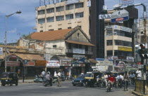 Street scene.  Traffic at traffic lights with old and modern architecture and advertising hoardings.