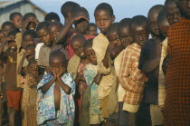 Hutu refugee children at Henu Oshinga camp waiting for distribution of clothing.